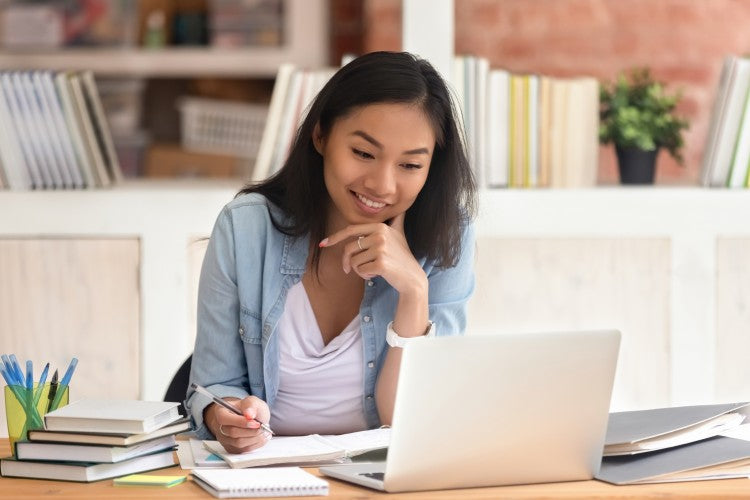 High school student works on laptop.