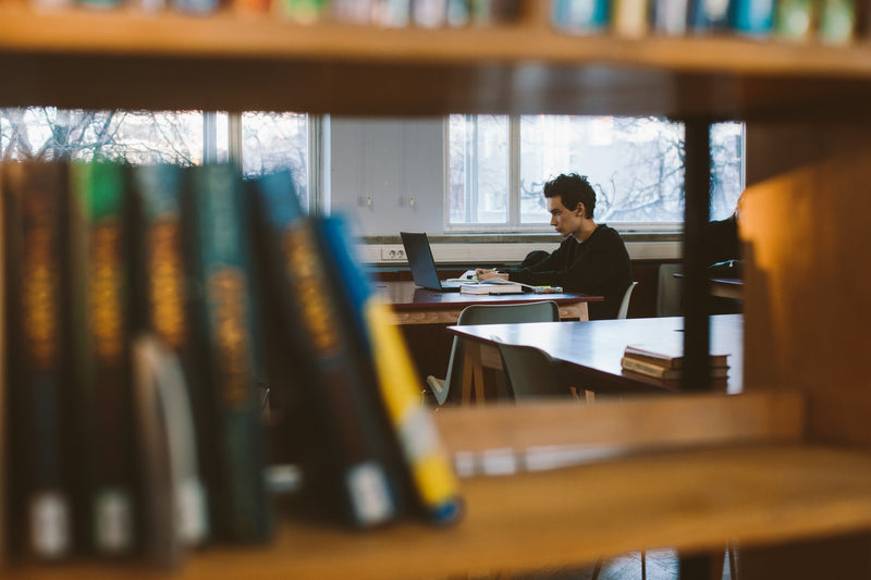 Student studies in library.