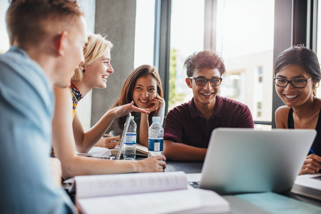 A group of high school students work together on a project. 